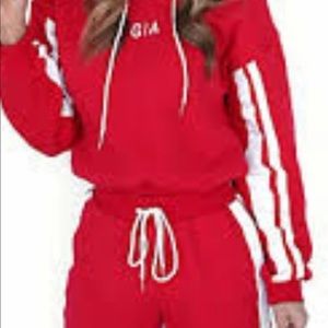Small red with white warmup or jogging suit